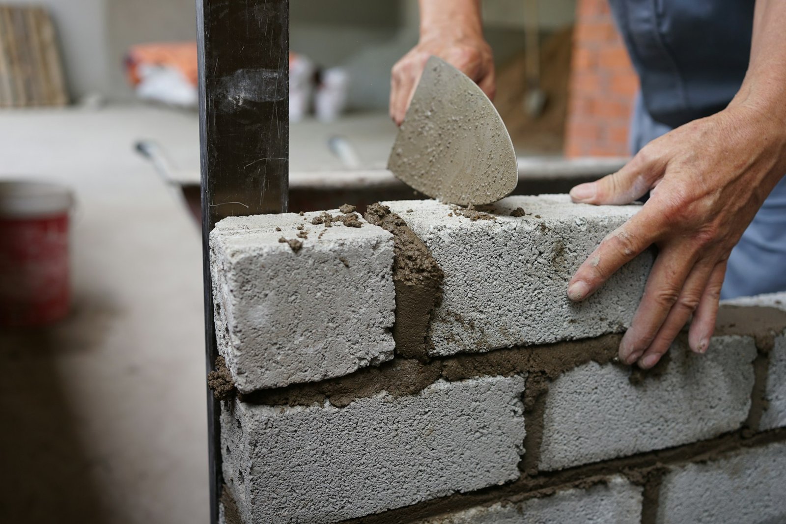 Bricklayer building a brick wall for a masonry project