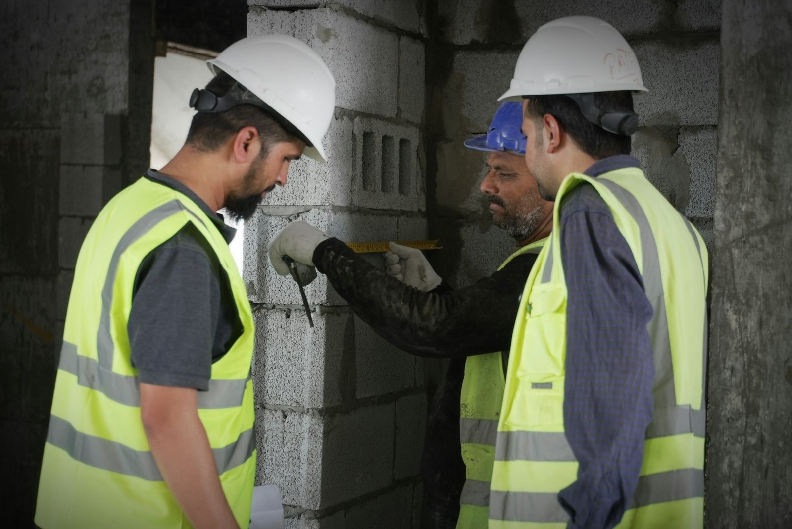 Construction team in safety vests reviewing a project