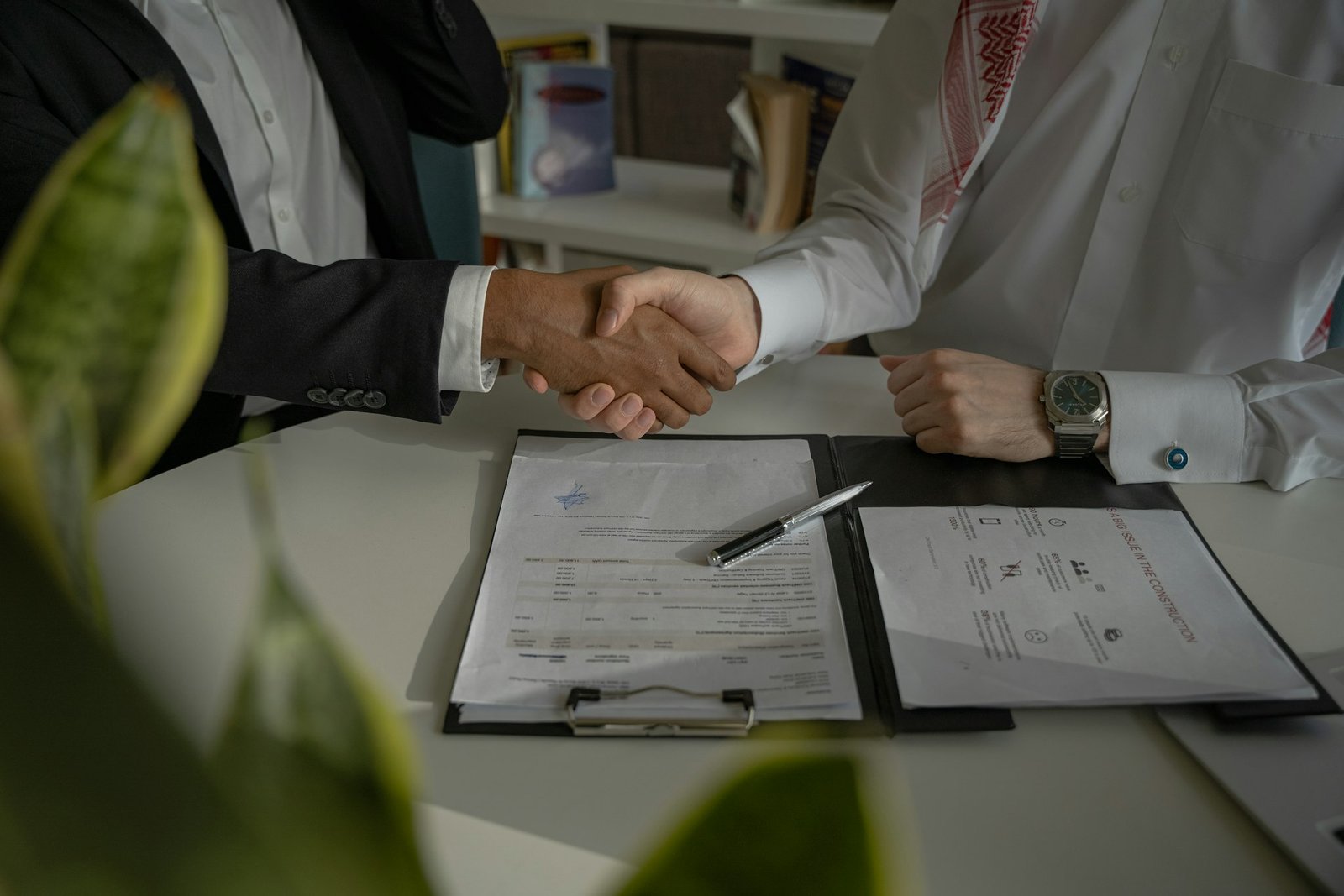 Homeowner and contractor shaking hands over an estimate